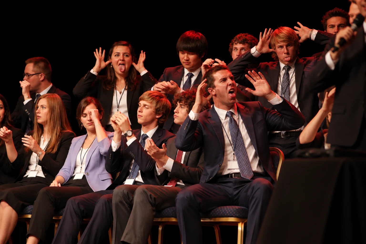 Hypnotized volunteers making funny faces on stage at a corporate hypnosis show
